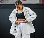 Karate woman ready for fitness workout at gym, learning at a sport club and doing training exercise at a wellness school or studio. Female dojo student preparing for fighting competition at center