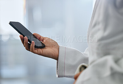 Buy stock photo Karate student athlete hand texting message on a phone at sport gym and browsing the internet with online social media app. Networking on 5g wireless mobile device or smartphone on the web with wifi