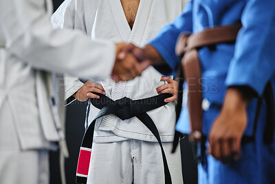 Buy stock photo Handshake, karate and martial arts teamwork in competition, challenge and combat fight in wellness studio. Black belt trainer and sports fitness coach in gym workout, exercise and training for health