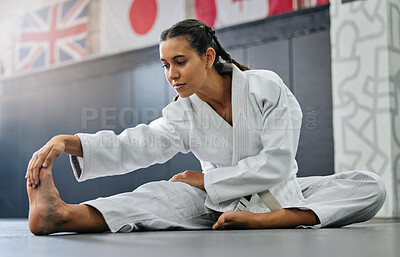Buy stock photo Exercise, fight and workout stretch of a karate school student with focus before training start. Sport woman or coach stretching for an exercise at a dojo studio, performance gym or martial arts club
