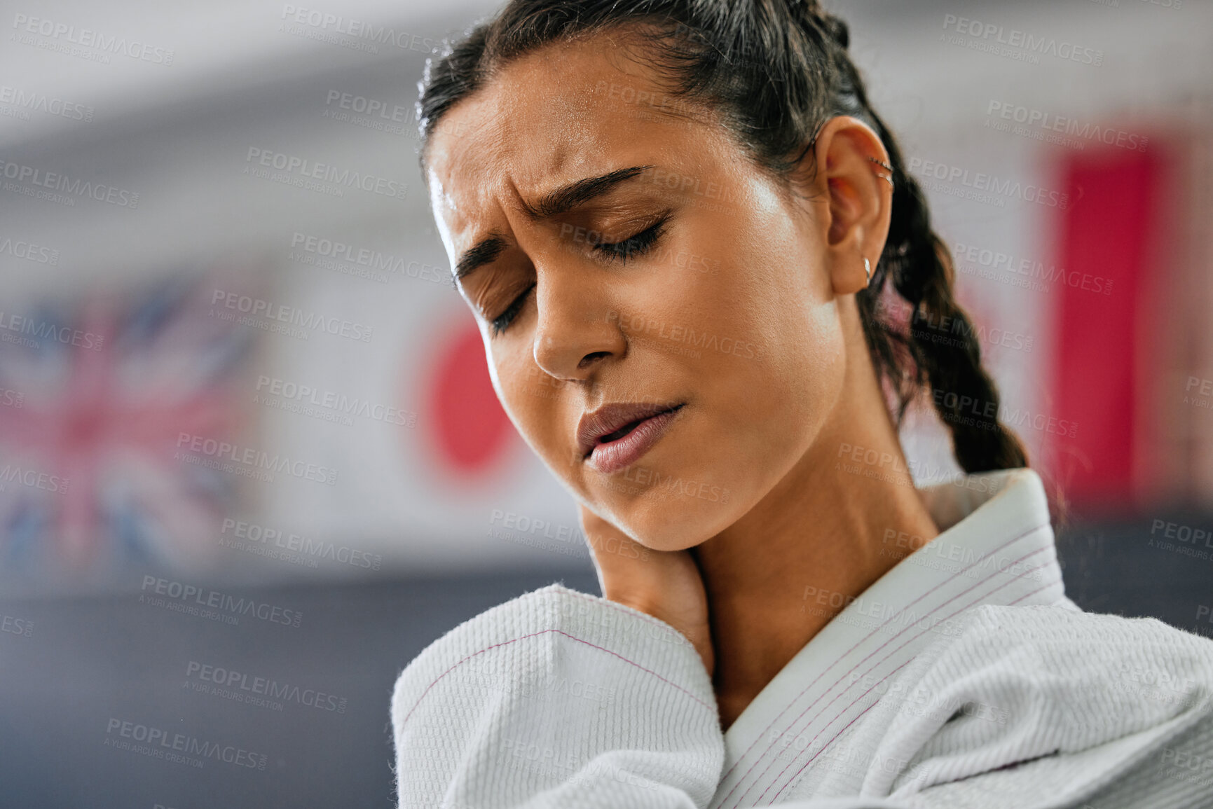 Buy stock photo Sports injury, closeup and pain in neck at martial arts practice. Mma fitness studio woman injured while training at the dojo. Face of karate student and fighter at gym hurt in training.
