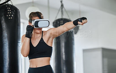 Buy stock photo Healthy, fit and active boxing woman with a VR headset to access the metaverse while exercising, training and working out in a gym. Female boxer doing a workout in virtual reality with technology.