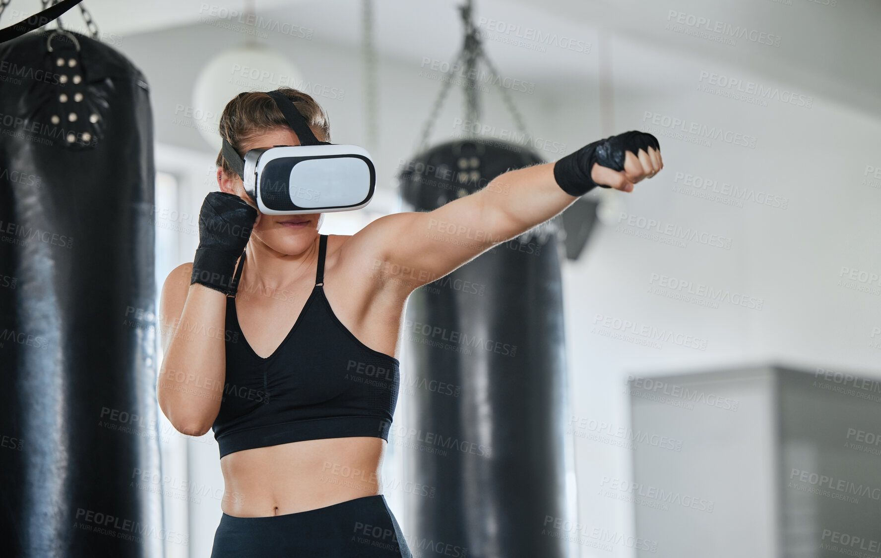 Buy stock photo Healthy, fit and active boxing woman with a VR headset to access the metaverse while exercising, training and working out in a gym. Female boxer doing a workout in virtual reality with technology.
