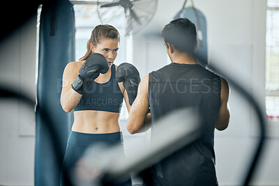 Buy stock photo Boxing fitness training with coach at gym, angry woman learning self defense with trainer and learning cardio exercise for wellness at sports club. Male instructor teaching workout class at center