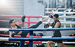 Fit, active and healthy fitness athletes exercise training together in boxing ring in modern sports gym. Sporty and strong woman workout with her combat coach trainer together in fighting studio