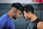 Healthy, serious and fit male athletes staring, facing and looking ready before a fight. Two strong young men in an active challenge, a battle of power against strength and a motivation for winning.
