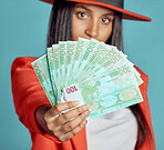 Rich, stylish and trendy woman showing her wealth and success in fashion posing over copy space. Fashionable female advertising a cash prize or lottery winner for a competition to win money.