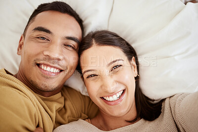 Buy stock photo Happy, smiling and in love young couple enjoying spending time together at home in bed inside. Portrait of romantic and loving partners with a smile looking cheerful, positive and excited for the day