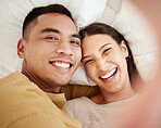 A happy and in love couple taking a selfie while smiling, laughing and looking cute portrait. Romantic, fun and sweet boyfriend and girlfriend bonding, relaxing and enjoying quality together in bed 
