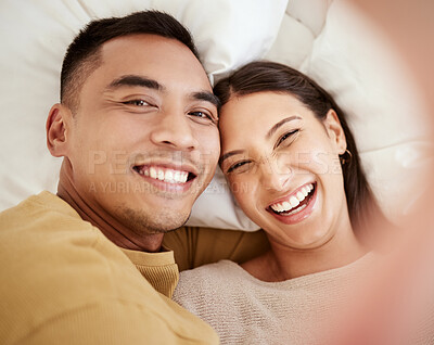 Buy stock photo A happy and in love couple taking a selfie while smiling, laughing and looking cute portrait. Romantic, fun and sweet boyfriend and girlfriend bonding, relaxing and enjoying quality together in bed 