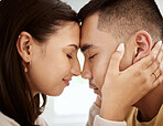 Dating, man and woman with foreheads against each other in a loving and affectionate closeup. In love, young male and female couple sharing a beautiful moment and smiling after their engagement.