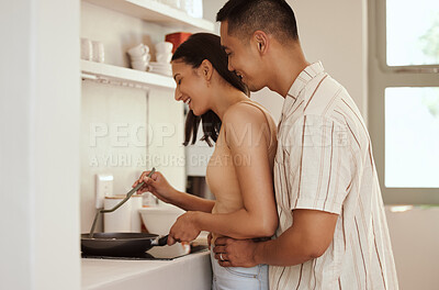 Buy stock photo Romantic, loving and caring couple cooking and bonding while hugging in the morning at home. Smiling husband and wife holding each other and embracing in kitchen while showing affection and in love