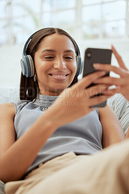 Buy stock photo Happy, smiling woman listening and browsing music on her phone during a break at work. Business woman enjoying some free alone time at the office texting and catching up on her social media.