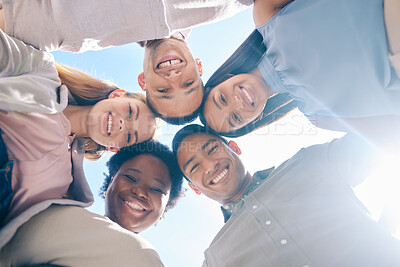 Buy stock photo Diverse group of friends in a huddle together showing unity, trust and support outdoors in summer from below. International, happy and young men and women smiling, united and cheerful team outside
