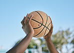 Basketball, sport and playing with a ball in the hands of a player, athlete or professional sportsperson. Closeup of a game or match outside on a court for health, recreation and fun in the sun