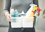 Woman, cleaner or housewife holding cleaning supplies, detergents and hygiene tools or products in a basket. Hands of a housekeeper ready to do chores and housework for a clean and tidy home
