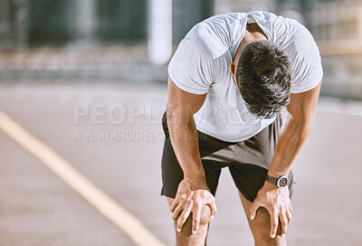 Buy stock photo Tired man resting after fitness run, taking a break from cardio training and doing wellness exercise on the road in the urban city. Exhausted and fit sports person doing routine workout in street