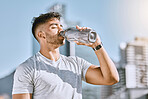 Fitness, healthy thirsty man drinking water while he is exercising outside in sportswear. Runner, cardio workout and active lifestyle for strong athletic body or mental discipline.