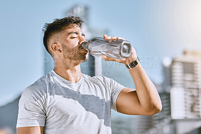 Buy stock photo Fitness, healthy thirsty man drinking water while he is exercising outside in sportswear. Runner, cardio workout and active lifestyle for strong athletic body or mental discipline.