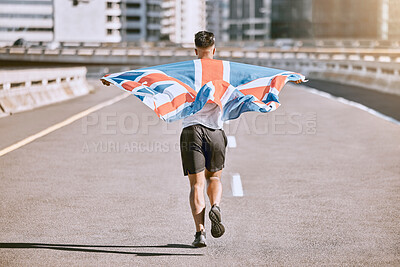 Buy stock photo Winner, flag and fitness man running on the city road celebrates winning achievement in summer. Sports, training and competitive British male runner doing healthy exercise in celebration outside