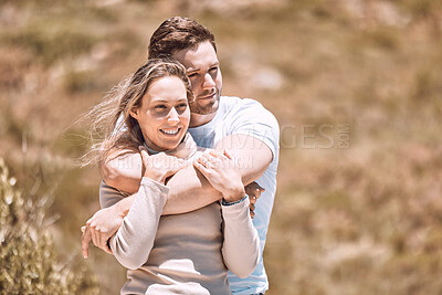 Buy stock photo Love, romance and dating with an affectionate young couple hugging, bonding and spending time together outside. Happy, loving and smiling man and woman embracing during a date outdoors in nature