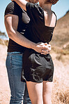 romantic, sweet and in love couple hugging or embracing each other together in outdoors nature walk together. happy and caring boyfriend holding lovely girlfriend, showing loving dating relationship 