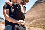 Kissing, hugging and embracing couple feeling in love, romantic or content while standing close together outside. Man and woman bonding, enjoying time or getaway weekend on break, holiday or vacation