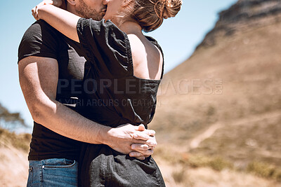 Buy stock photo Kissing, hugging and embracing couple feeling in love, romantic or content while standing close together outside. Man and woman bonding, enjoying time or getaway weekend on break, holiday or vacation