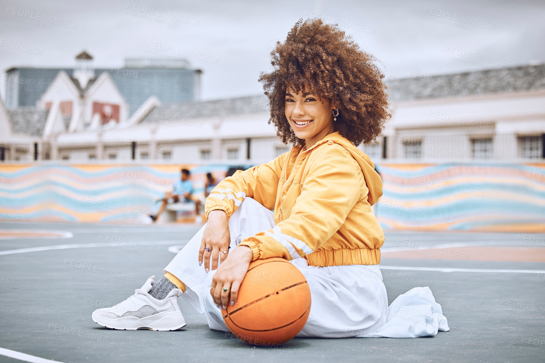 Buy stock photo Beautiful, young and female basketball coach with an afro sitting on the court outside. Portrait of a professional, confident and healthy athlete woman in sports, health and fitness.