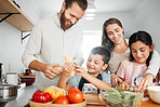 Healthy dinner, cooking and bonding of a family making and preparing food together in a kitchen. Smiling parents teaching happy young kids how to make a health meal with organic vegetables at home
