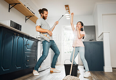 Buy stock photo Having fun doing chores, dancing and singing father and daughter cleaning the living room together at home. Carefree, happy and cheerful parent bonding, doing housework and playing with little girl