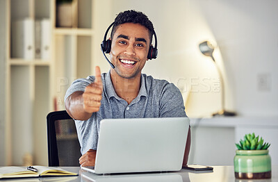 Buy stock photo Thumbs up by call center, looking pleased and showing support with hand gesture while working on a laptop in an office alone at work. Portrait of an excited customer service agent expressing thanks