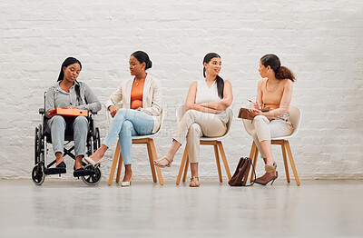 Buy stock photo Inclusive group of women sharing idea and goals, planning and talking, sitting together at work. Diverse creative team chatting, brainstorming, discussing an idea for a startup or marketing strategy