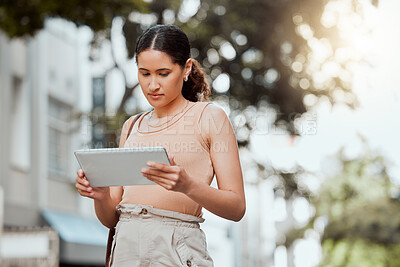 Buy stock photo Reading, checking or browsing social media on tablet while out commuting through city and looking for directions or inspiration online. Young entrepreneur using business website tool for ideas