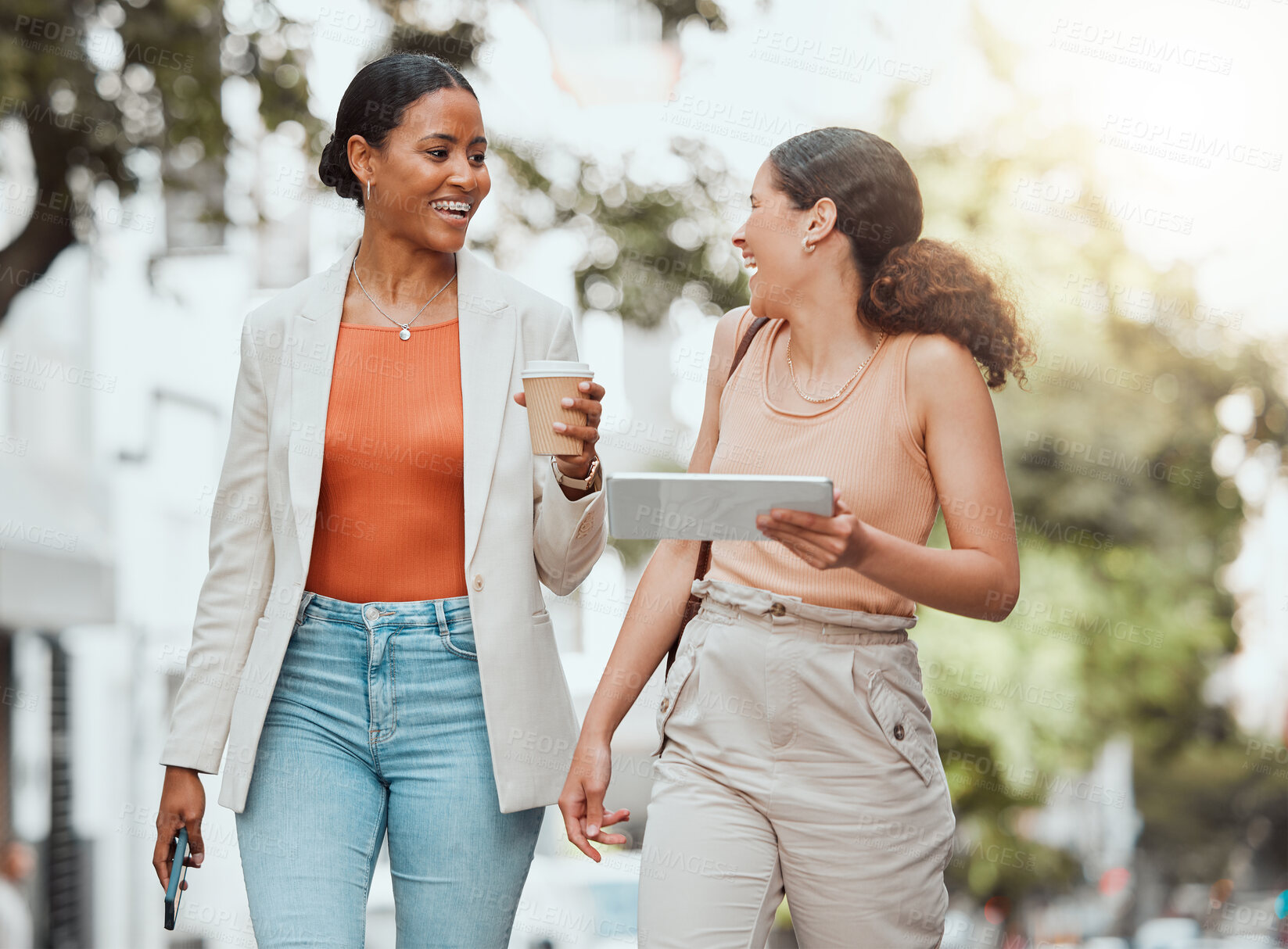 Buy stock photo Friends walking and talking on university campus, having fun and laughing in the city. Carefree, happy and cheerful young female college students enjoying outdoor meeting, having takeout coffee. 