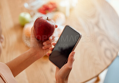 Buy stock photo Online, health and apple organic fruit of woman holding phone and looking at nutrition value. Young female browsing diet and wellness plan or recipes to make for a healthy meal and lifestyle.