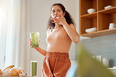 Buy stock photo Eating, tasting and drinking a green health smoothie with a young female in a kitchen. Woman on a weight loss, organic and fresh fruit and food diet for wellness, nutrition and a healthy lifestyle