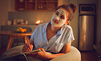 Thinking woman writing in book, doing face mask for skincare and grooming while sitting on the couch alone at home. Creative female looking thoughtful while planning routine in journal on the sofa