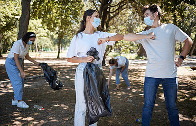Buy stock photo Recycle, volunteer and responsible activist for covid cleaning community park while greeting teamwork with elbow bump. Collecting litter, garbage and trash for sustainable, clean and safe environment