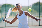 Fit, active and athletic tennis player playing a serious competitive match at a sports court. Female athlete practicing her aim during a game. Woman enjoying a outdoor hobby she is passionate about.