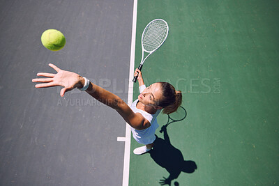 Buy stock photo Fit tennis player, sport and serving during training, workout and exercise or match, game and competition from above. Sporty, active and healthy woman throwing a ball and practicing serve with racket