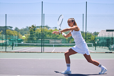 Fit, active and sport with athletic tennis player playing competitive match at a tennis court. Female athlete practicing her aim during a game. Lady enjoying active hobby she\'s passionate about