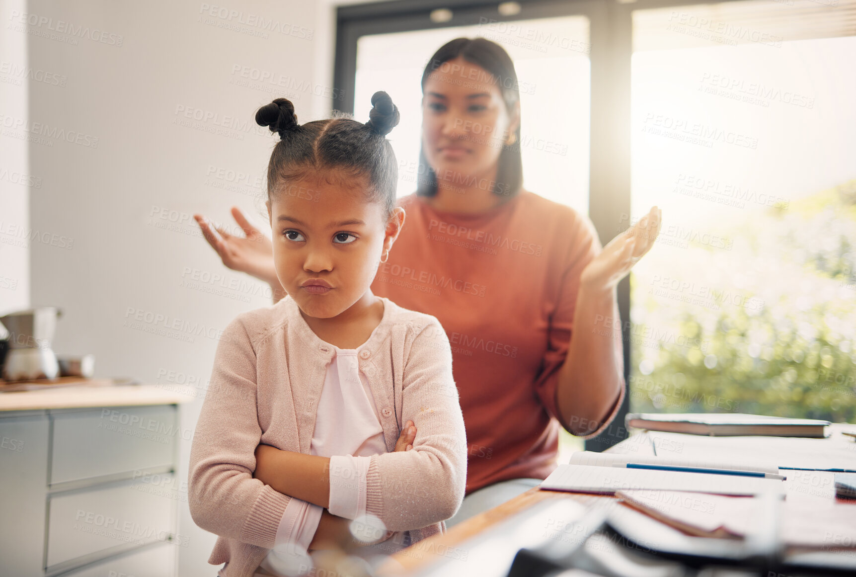 Buy stock photo Upset, discipline and family while offended and stubborn little girl looking unhappy with her scolding mother in the background. Naughty, problem and bad child angry and ignoring her parent at home 
