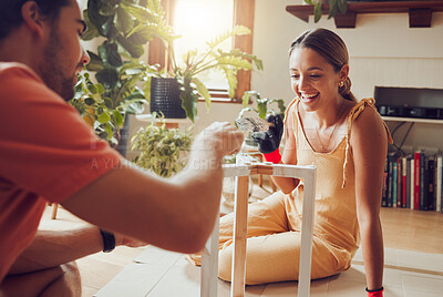Buy stock photo DIY, home improvement and fun couple painting a table or doing chores together at home and enjoying housework. Joyful, excited and cheerful lovers laughing and decorating their house