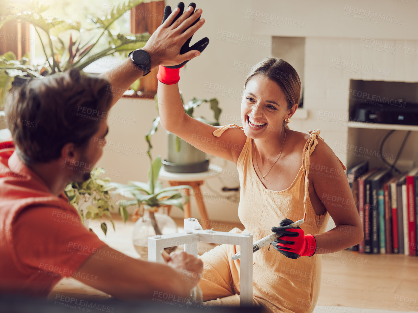 Buy stock photo Couple doing high five, well done or good job gesture while painting or remodelling furniture, wooden table for home improvement or interior decor. A man and woman with fun, creative DIY activity