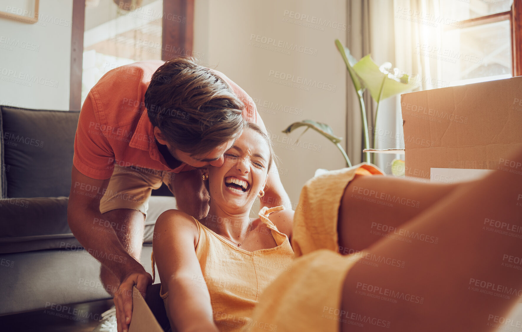 Buy stock photo Playful and fun couple moving into their new house, celebrating by being goofy and fooling around. Affectionate boyfriend and girlfriend enjoying their freedom, laughing, bonding and playing 