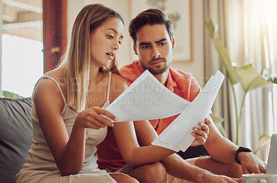 Buy stock photo Budget, debt and mortgage with a couple reading bills and documents while checking their expenses and savings. Husband and wife looking worried while reading a loan application or contract together
