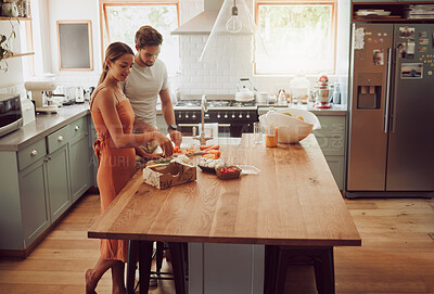 Buy stock photo Couple cooking, home food or healthy meal for bonding, happy or fun man and woman in house kitchen together. Conversation, love or young people in modern interior with fresh salad vegetables on table