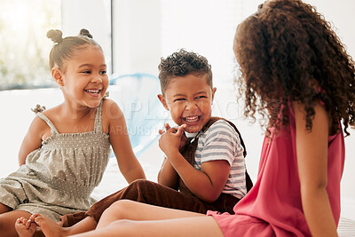 Buy stock photo Happy, cheerful and laughing children sitting together and having fun at a playdate. Adorable boy and girls enjoying their time together at home. Siblings, sisters and brother bonding and playing