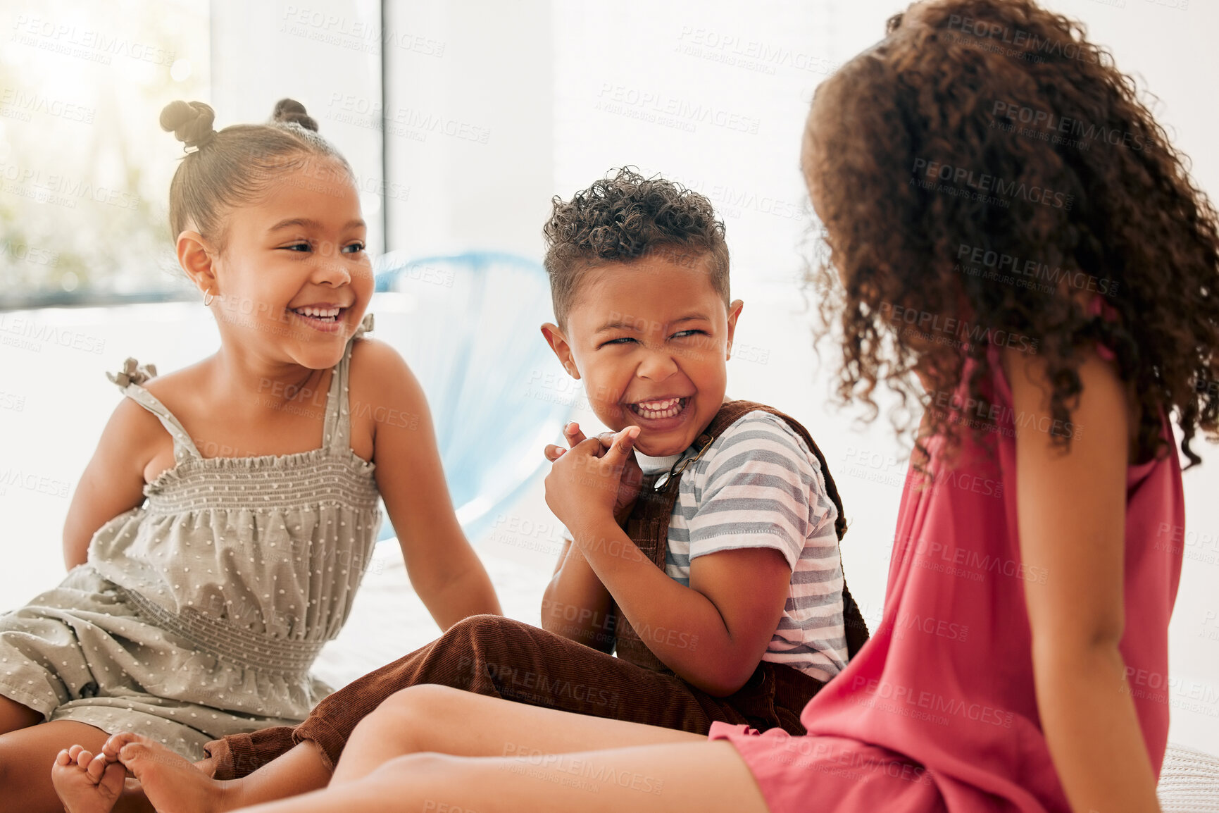 Buy stock photo Happy, cheerful and laughing children sitting together and having fun at a playdate. Adorable boy and girls enjoying their time together at home. Siblings, sisters and brother bonding and playing